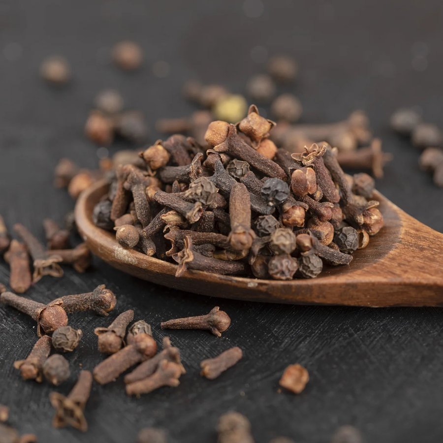 Indonesian dried cloves on a wooden spoon